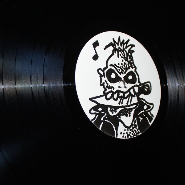 photo du vinyle "Sauvages" de HAINE BRIGADE, avec sur le rond central un squelette punk avec une crête, un blouson de cuir et un couteau entre les dents